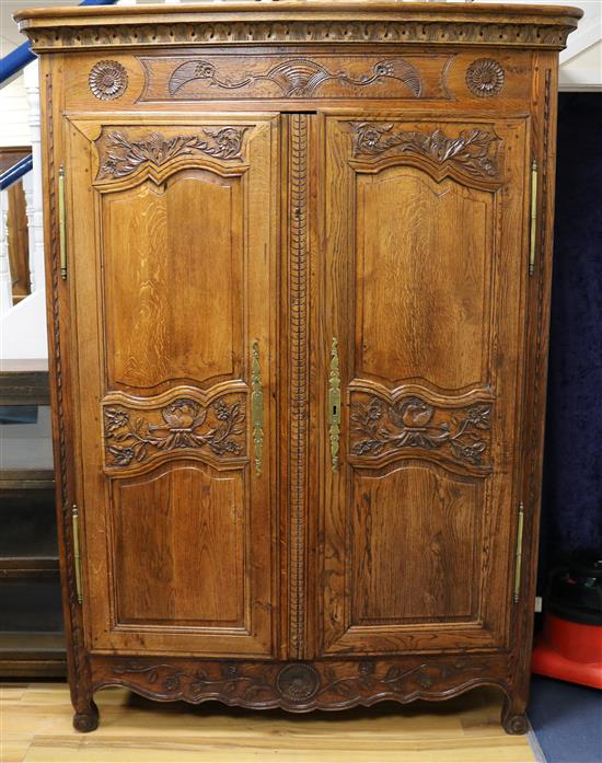 A late 18th century French provincial carved oak two door armoire W.130cm